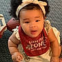Truth joined the competition — help win amazing prizes! baby, infant, headband, bib, red_bib, curly_hair, carpet, football, wooden_toy, sitting, cute, child, indoor, clothing, playtime, expression, person, skin, hand, foot