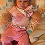 Truth is registered to the contest to win money with this photo: baby, blanket, bow, child, comfortable, cushion, cute, elephant_pattern, face, headband, indoors, infant, lying_down, pacifier_clip, patterned_bedding, person, pink_clothing, rainbow_pattern, small_hands, soft_texture