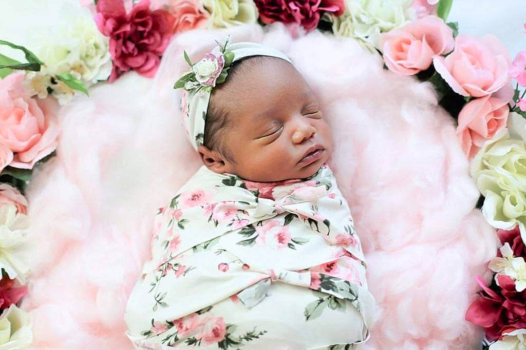 Kobi joined the competition — help win amazing prizes! baby, baby_toddler_clothing, cheek, child, face, facial_expression, flower, flower_arranging, grass, happy, headgear, lip, person, petal, pink, plant, red, rose, skin, textile