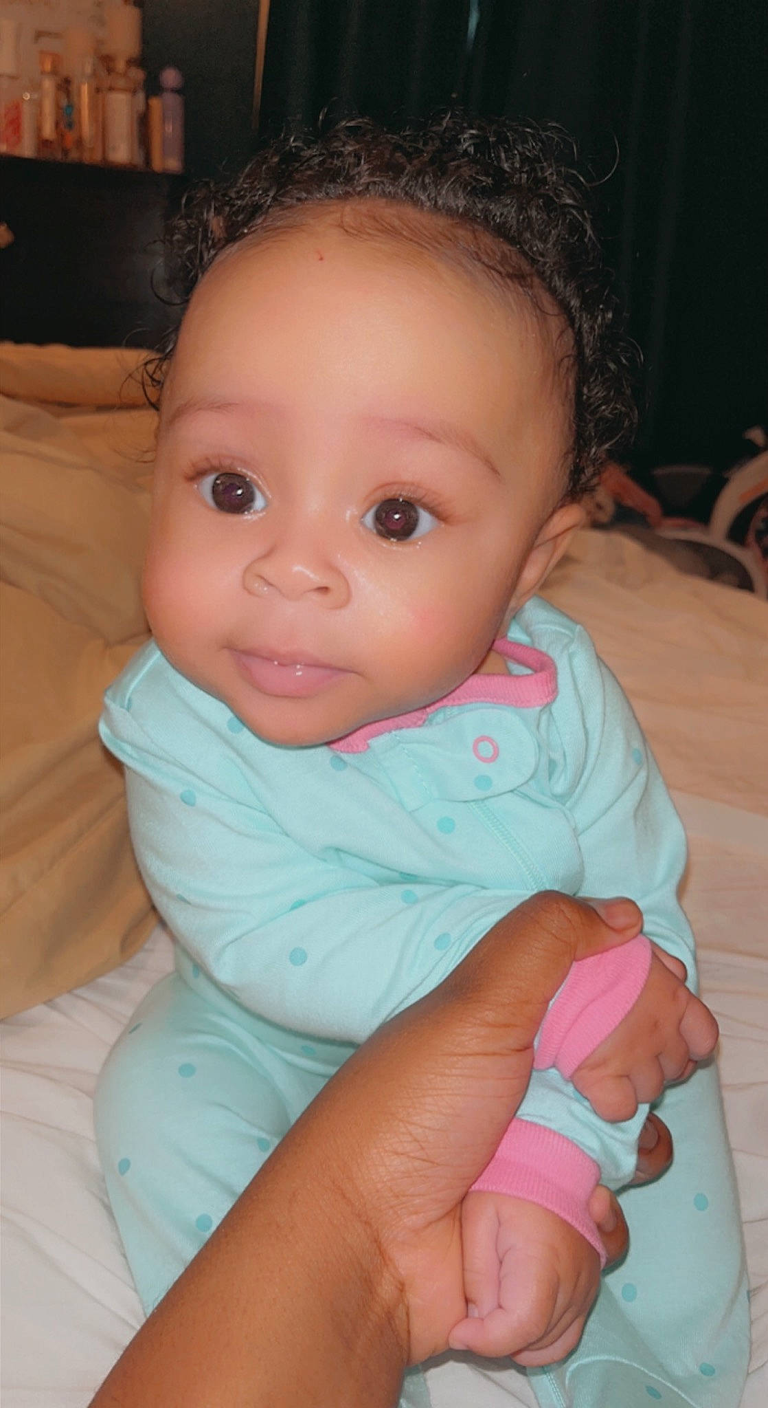 Avonna is registered to the contest to win money with this photo: arm, baby, baby_toddler_clothing, cheek, comfort, eye, eyelash, facial_expression, hairstyle, hand, head, iris, lip, mammal, mouth, nose, organ, person, product, skin