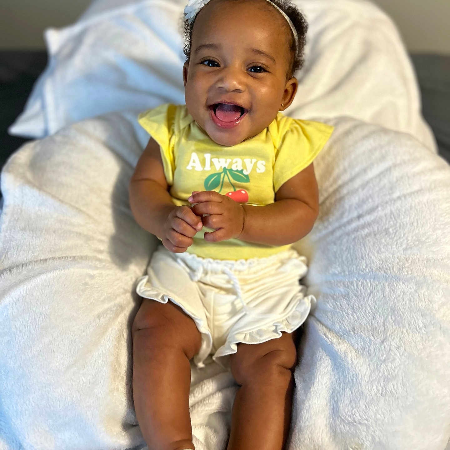 Raeni joined the competition — help win amazing prizes! baby, babylaughing, clothing, couch, diaper, face, footwear, furniture, happy, head, laughing, pants, person, photography, portrait, sandal, shorts, sitting, smile, t_shirt
