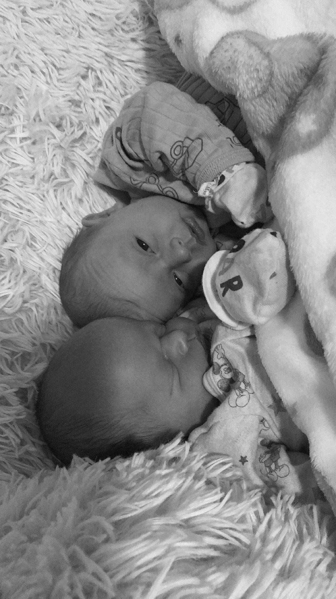 Weston And Keyston is registered to the contest to win money with this photo: arm, baby, black_and_white, cheek, comfort, eye, eyebrow, face, gesture, happy, head, human_body, interaction, iris, lip, mouth, nose, person, skin, textile