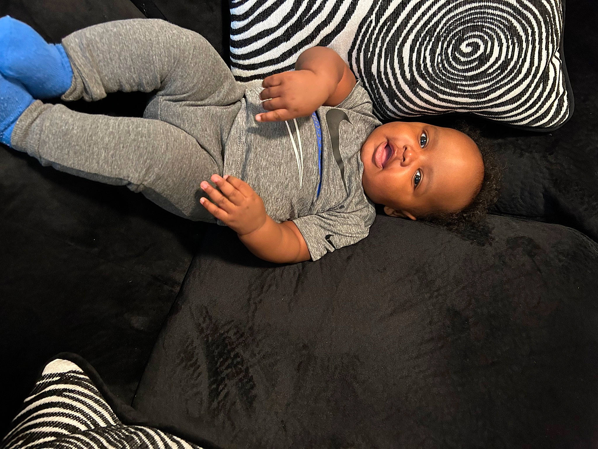 Khalil is registered to the contest to win money with this photo: black, comfort, elbow, flash_photography, flooring, fun, gesture, hat, human_leg, joint, knee, leg, mammal, person, t_shirt, thigh, toddler, tree, vertebrate, white