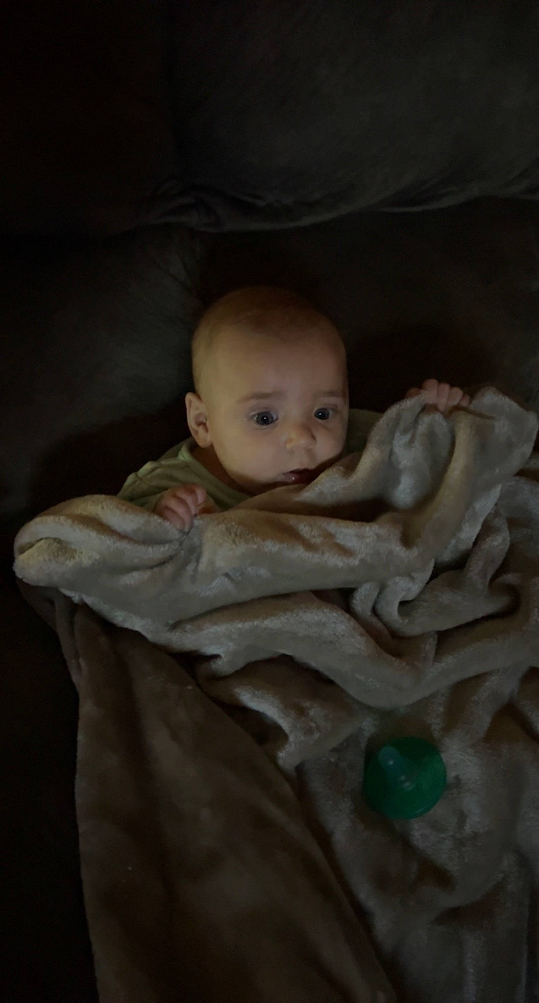 Oakley is registered to the contest to win money with this photo: baby, baby_products, baby_toddler_clothing, cheek, child, comfort, darkness, eye, flash_photography, fur, iris, linens, person, room, sitting, skin, toddler, toy, wood