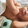 baby, infant, blanket, plush_toy, soft_toy, cuddling, lying_down, face, arm, hand, skin, expression, cozy, closeup, indoors, comfort, child, sleepy, peaceful, resting