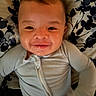 Wyatt is registered to the contest to win money with this photo: baby, child, smiling, onesie, blanket, face, portrait, infant, happy, drool, cute, lying_down, young_child, person, indoors, closeup, head, skin, expression, sleepwear