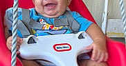 Wyatt is registered to the contest to win money with this photo: baby, swing, smile, child, happy, red, seat, safety_harness, blue_shirt, indoor, play, infant, ropes, cute, person, feet, hand, portrait, fun, young