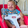 baby, swing, smile, child, happy, red, seat, safety_harness, blue_shirt, indoor, play, infant, ropes, cute, person, feet, hand, portrait, fun, young
