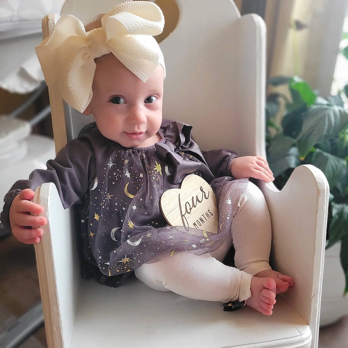 Lilyana joined the competition — help win amazing prizes! baby, baby_safety, baby_toddler_clothing, child, comfort, doll, facial_expression, finger, happy, headwear, houseplant, human_leg, person, plant, sitting, skin, sleeve, smile, thigh, toddler