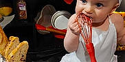 Nyx joined the competition — help win amazing prizes! baby, child, chef_hat, apron, whisk, baking, kitchen, eggs, bread, flour, cooking, food, cute, infant, playful, sitting, indoors, tableware, utensil, smiling