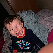 Braxton joined the competition — help win amazing prizes! toddler, child, smiling, happy, bed, blanket, pillow, indoor, cozy, clothing, person, face, hair, expression, playing, cute, young, fun, joy, sleepwear