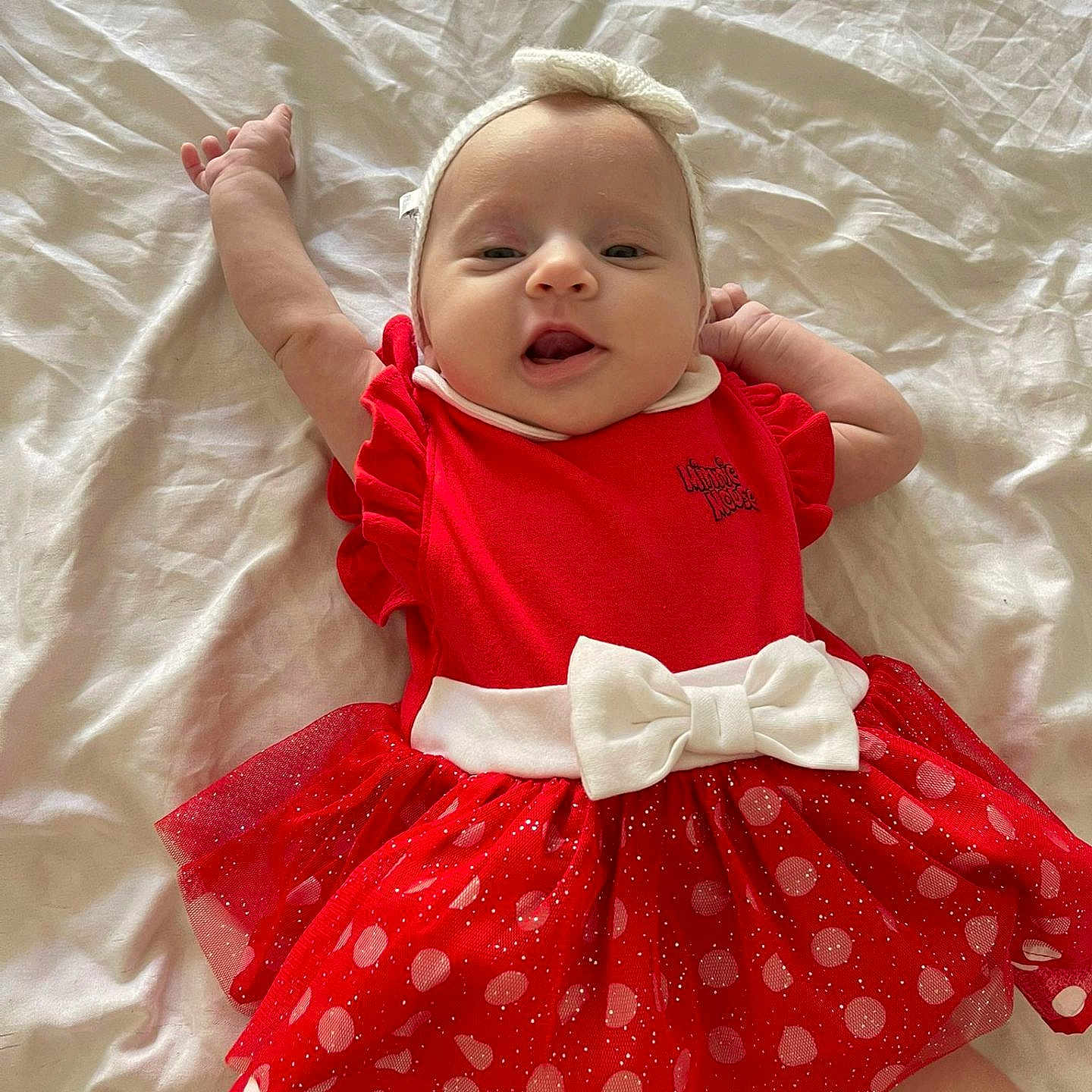 Sienna participe au concours pour gagner de l'argent avec cette photo : adorable, baby, bed_sheet, child, cute, fashion, happy, headband, indoors, infant, lying_down, polka_dot, portrait, red_dress, small_hands, smiling, stretching, toddler, white_bow, young