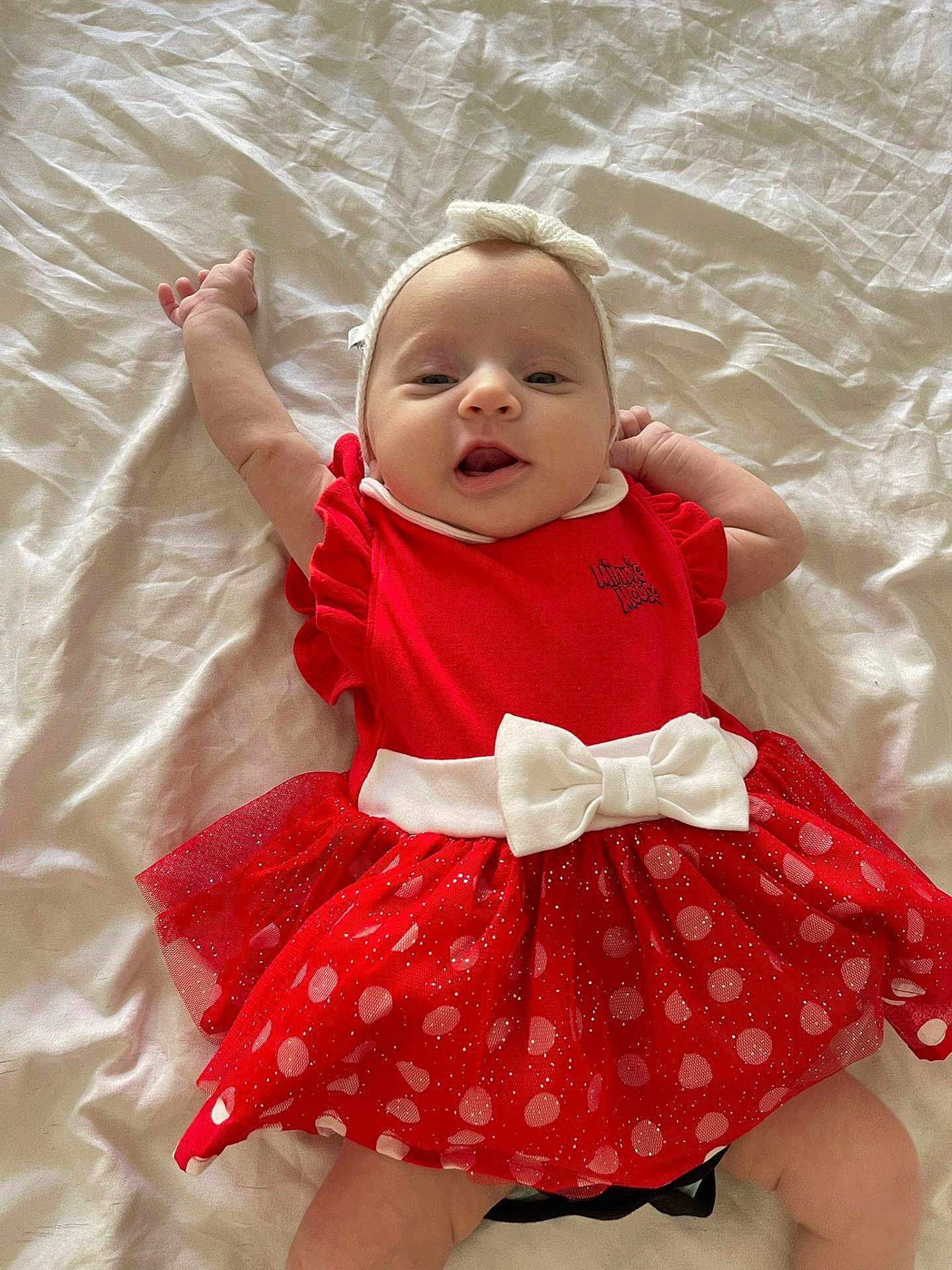Sienna participe au concours pour gagner de l'argent avec cette photo : baby, infant, red_dress, white_bow, headband, polka_dot, smiling, lying_down, happy, child, cute, young, indoors, bed_sheet, stretching, small_hands, adorable, portrait, toddler, fashion
