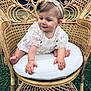 Rosie participe au concours pour gagner de l'argent avec cette photo : baby, child, white_dress, headband, rattan_chair, cushion, outdoor, grass, cute, smiling, portrait, sitting, hand, foot, furniture, nature, young_child, curious, lace, person
