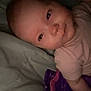 Aurora is registered to the contest to win money with this photo: baby, infant, face, bed, blanket, sleepy, lying_down, cozy, pajamas, child, soft, portrait, closeup, indoors, cute, skin, head, expression, comfort, rest