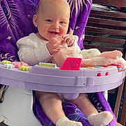 Aurora joined the competition — help win amazing prizes! baby, child, smiling, toy, purple_blanket, baby_chair, indoor, socks, happy, plaything, wooden_chair, furniture, table, household_items, infant, cute, seated, person, blanket, smile