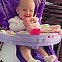 baby, child, smiling, toy, purple_blanket, baby_chair, indoor, socks, happy, plaything, wooden_chair, furniture, table, household_items, infant, cute, seated, person, blanket, smile