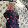 newborn, baby, sleeping, onesie, navy_blue, red_crabs, blanket, teddy_bear_pattern, soft_light, infant, cute, cozy, indoors, child, portrait, peaceful, clothing, footed_pajamas, resting, small_hands