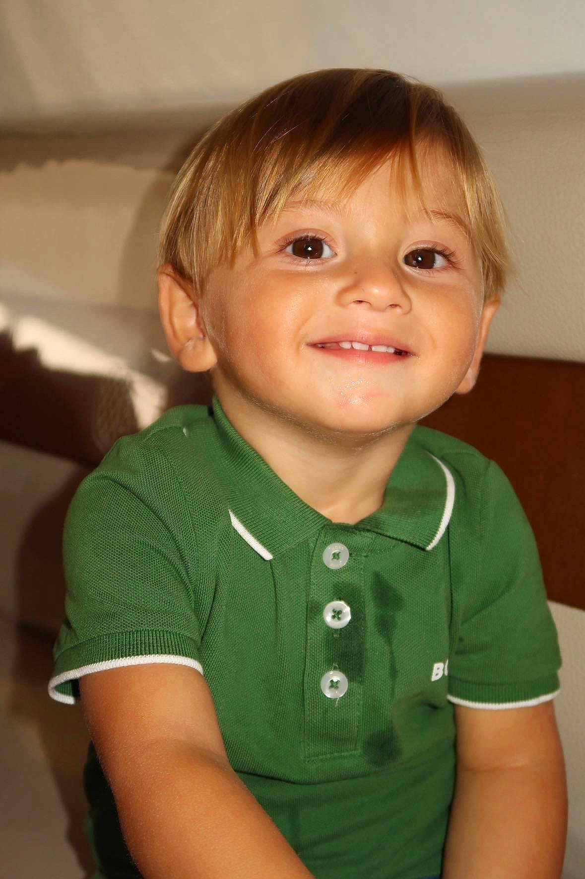 Aaron participe au concours pour gagner de l'argent avec cette photo : child, smile, green_polo_shirt, wet_stain, indoor, young_boy, short_hair, happy, portrait, sitting, casual_clothing, face, person, cute, light_skin, buttoned_shirt, brown_eyes, closeup, happy_expression, kid