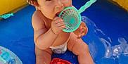 Sasha participe au concours pour gagner de l'argent avec cette photo : baby, blue, child, cute, diaper, fun, hat, inflatable, outdoor, plastic, playing, pool, red, sitting, summer, toddler, toy, water, water_play, yellow