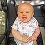 baby, cheerful, child, clothing, cute, face, hands, happy, infant, onesie, outdoor, person, pink, portrait, seatbelt, sitting, smiling, stroller, sunlight, white