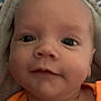 Aidyn joined the competition — help win amazing prizes! baby, close_up, face, infant, portrait, orange_clothing, blanket, soft_texture, child, cute, young, head, skin, eyes, smile, lying_down, indoors, person, newborn, expression