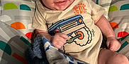 Aidyn is registered to the contest to win money with this photo: baby, infant, smiling, baby_seat, blanket, clothing, cute, monkey_pattern, colorful, happy, child, indoor, portrait, young_child, toddler, fabric, seat, comfort, playful, wrapped
