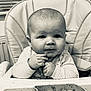 Freddie is registered to the contest to win money with this photo: baby, high_chair, food, messy, hands, face, expression, curious, striped_clothing, meal, indoor, window_blinds, plate, table, child, infant, feeding, cute, portrait, monochrome