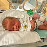 Matthew is registered to the contest to win money with this photo: newborn, baby, hospital, incubator, medical_equipment, sleeping, onesie, lion_prints, blanket, monitor, tube, infant, cute, healthcare, bed, resting, premature_baby, child, small, peaceful