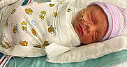 Matthew is registered to the contest to win money with this photo: newborn, baby, hospital, incubator, blanket, swaddled, sleeping, hat, oxygen_tube, medical, infant, cute, striped_hat, peaceful, face, child, bed, healthcare, person, resting