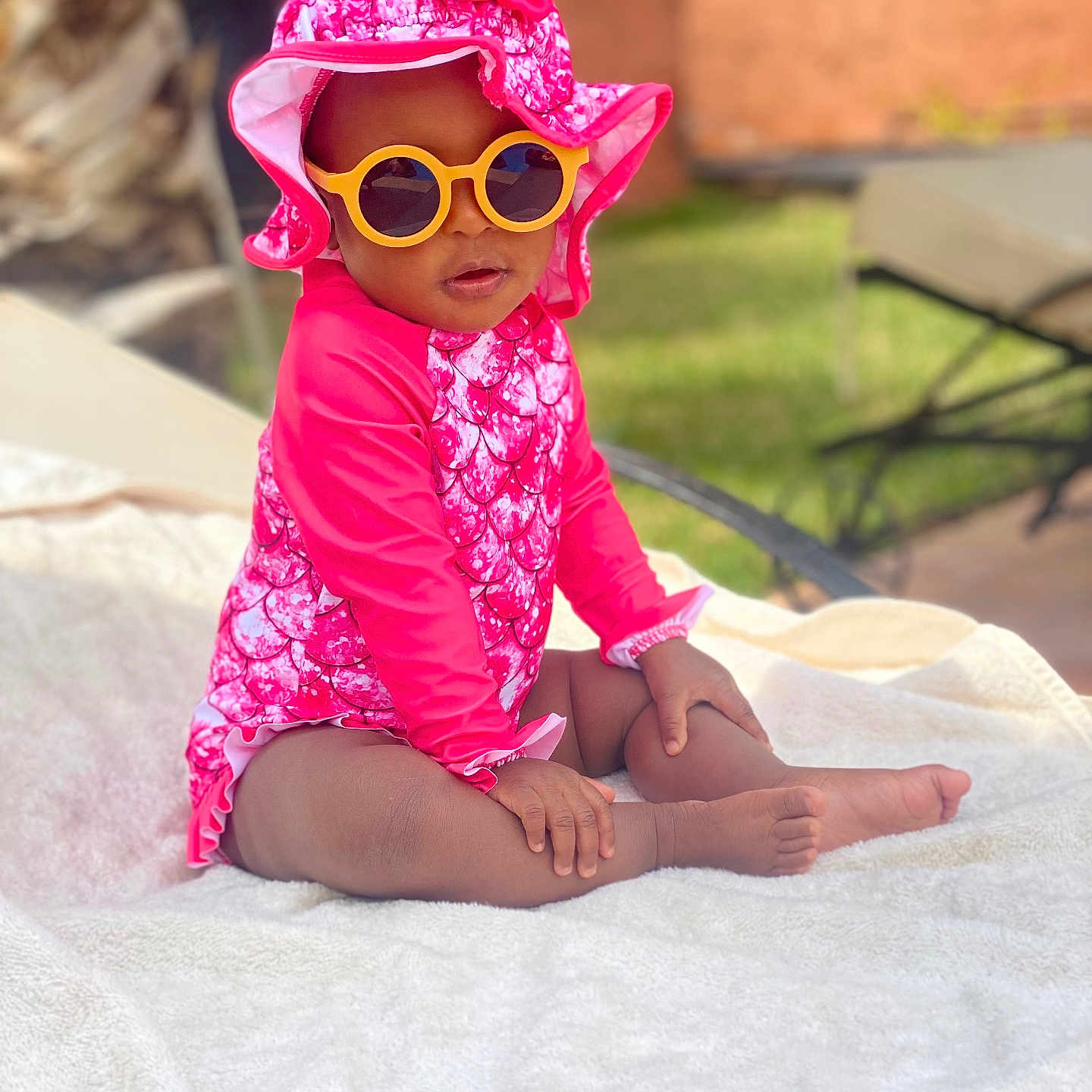 Ayna participe au concours pour gagner de l'argent avec cette photo : accessories, baby, bonnet, cap, clothing, coat, dress, face, glasses, grass, hat, head, hood, person, photography, portrait, sitting, summer, sunglasses, sunhat