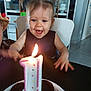 toddler, child, birthday, candle, cake, celebration, happy, excited, pigtails, face, mouth_open, table, plate, chocolate_cake, indoor, kitchen, chair, person, smile, lighting