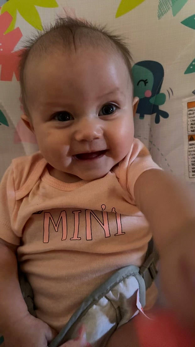 Coraline is registered to the contest to win money with this photo: baby, baby_toddler_clothing, cheek, chin, ear, eye, eyebrow, eyelash, facial_expression, forehead, happy, head, human_body, iris, joy, lip, mouth, nose, person, skin