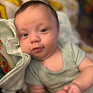 Timothy joined the competition — help win amazing prizes! baby, infant, child, face, skin, hand, clothing, blanket, fabric, portrait, cute, lying_down, soft_texture, closeup, newborn, smile, blue_eyes, indoors, comfort, resting