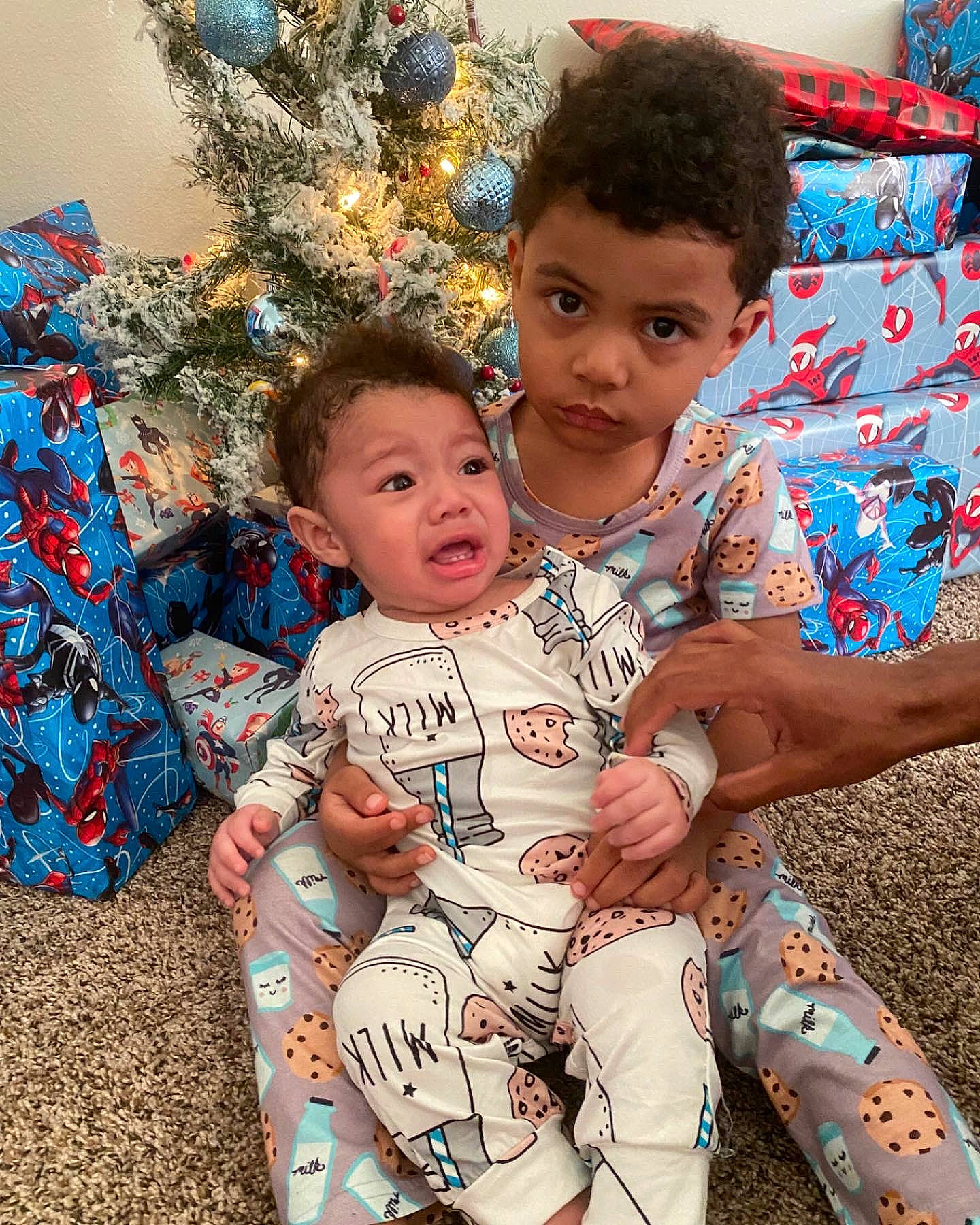 Cassian is registered to the contest to win money with this photo: baby, baby_toddler_clothing, blue, child, christmas_ornament, christmas_tree, community, event, facial_expression, fun, hairstyle, happy, head, holiday_ornament, leaf, people_in_nature, person, sitting, sorrow, standing