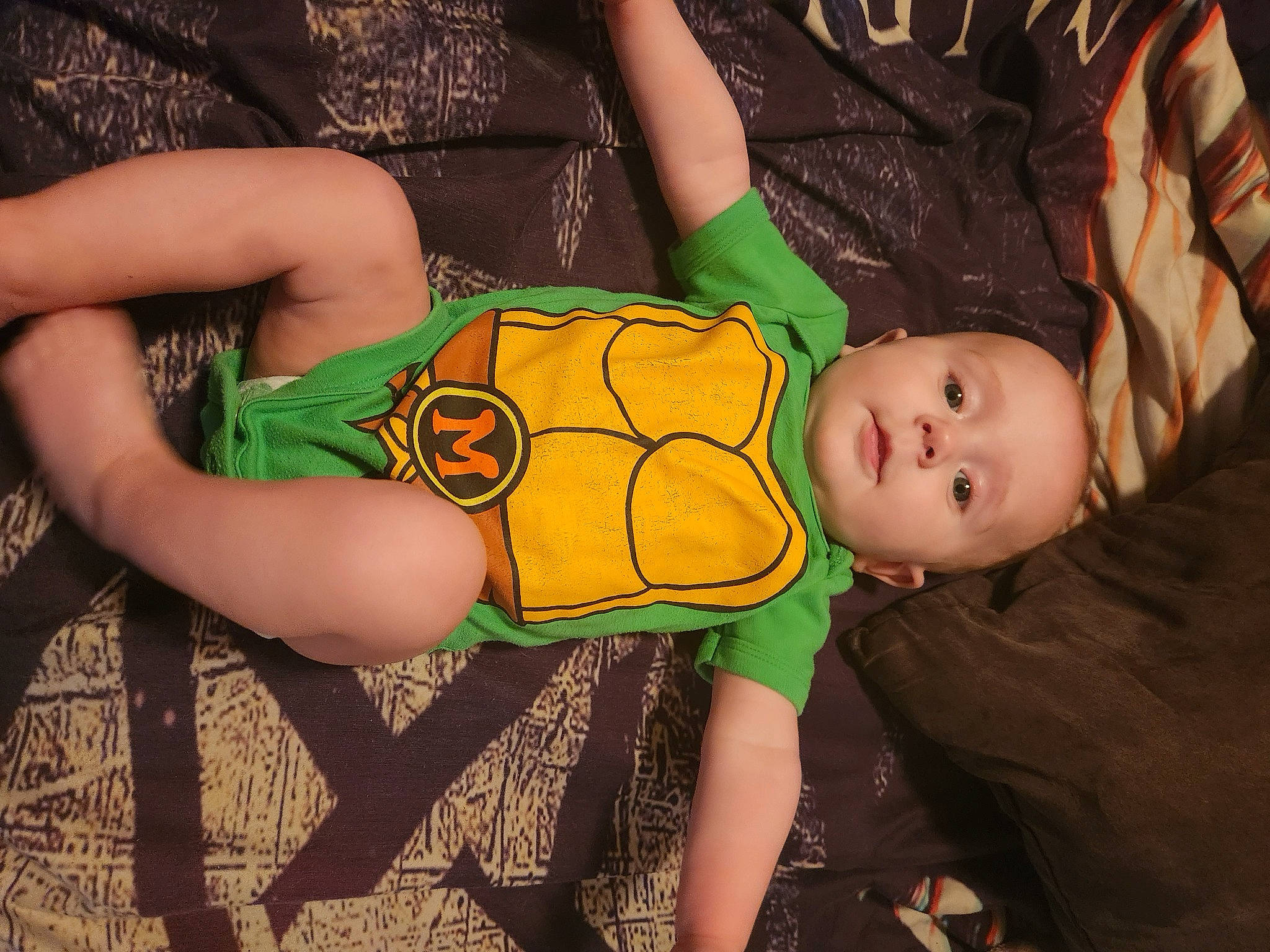 Harrison joined the competition — help win amazing prizes! baby, baby_toddler_clothing, child, comfort, elbow, foot, fun, happy, human_body, human_leg, knee, leg, nail, orange, pattern, person, sitting, sleeve, thigh, toddler