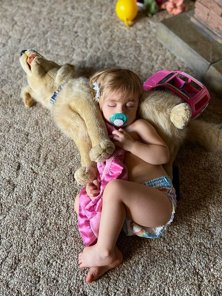 Madysyn is registered to the contest to win money with this photo: abdomen, baby, brassiere, child, companion_dog, dog_breed, fawn, foot, fun, fur, grass, happy, human_leg, mammal, paw, person, sitting, swimwear, thigh, toddler