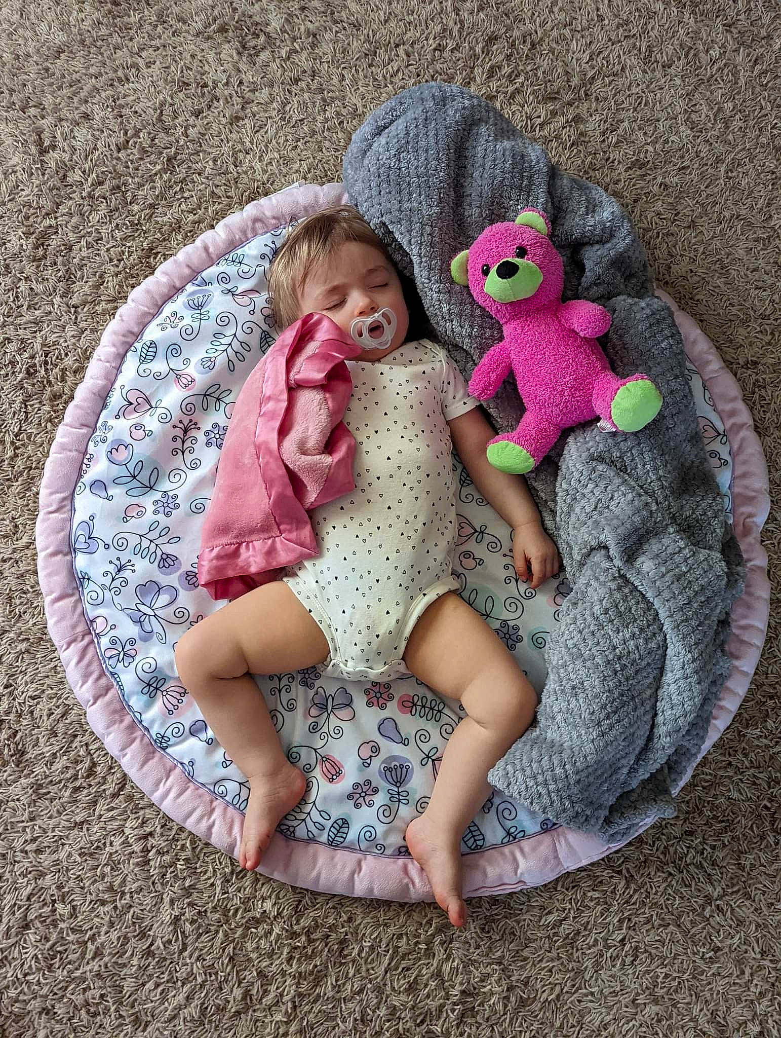 Madysyn is registered to the contest to win money with this photo: baby, baby_products, baby_toddler_clothing, cap, child, comfort, doll, dress, fawn, foot, grass, linens, magenta, pattern, person, pink, plant, purple, textile, toddler