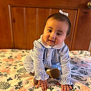 Melany joined the competition — help win amazing prizes! baby, blue_outfit, bow, child, cozy, crawling, curious, cute, feet, floral_blanket, hands, indoors, infant, person, portrait, smiling, soft_lighting, white_collar, wooden_background, young_child