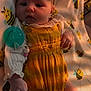 baby, infant, blanket, bee_pattern, yellow_romper, headband, pacifier, cute, soft_light, sleepwear, child, newborn, lying_down, indoors, adorable, face, skin, hand, foot, clothing
