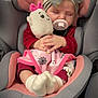 baby, car_seat, pacifier, plush_toy, headband, blanket, sleeping, infant, cute, pink, soft_toys, child, cozy, toddler, clothing, socks, hands, closed_eyes, seatbelt, indoors