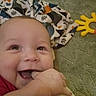 Austin joined the competition — help win amazing prizes! baby, smiling, chewing, bottle, hand, dinosaur_print, blanket, toy, yellow_toy, face, happy, child, infant, closeup, lying_down, soft_texture, cute, indoors, person, playtime