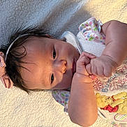 Hanny joined the competition — help win amazing prizes! baby, infant, face, hands, headband, bow, blanket, clothing, winnie_the_pooh, soft_toy, cute, portrait, lying_down, closeup, newborn, child, expression, warm_light, indoor, skin