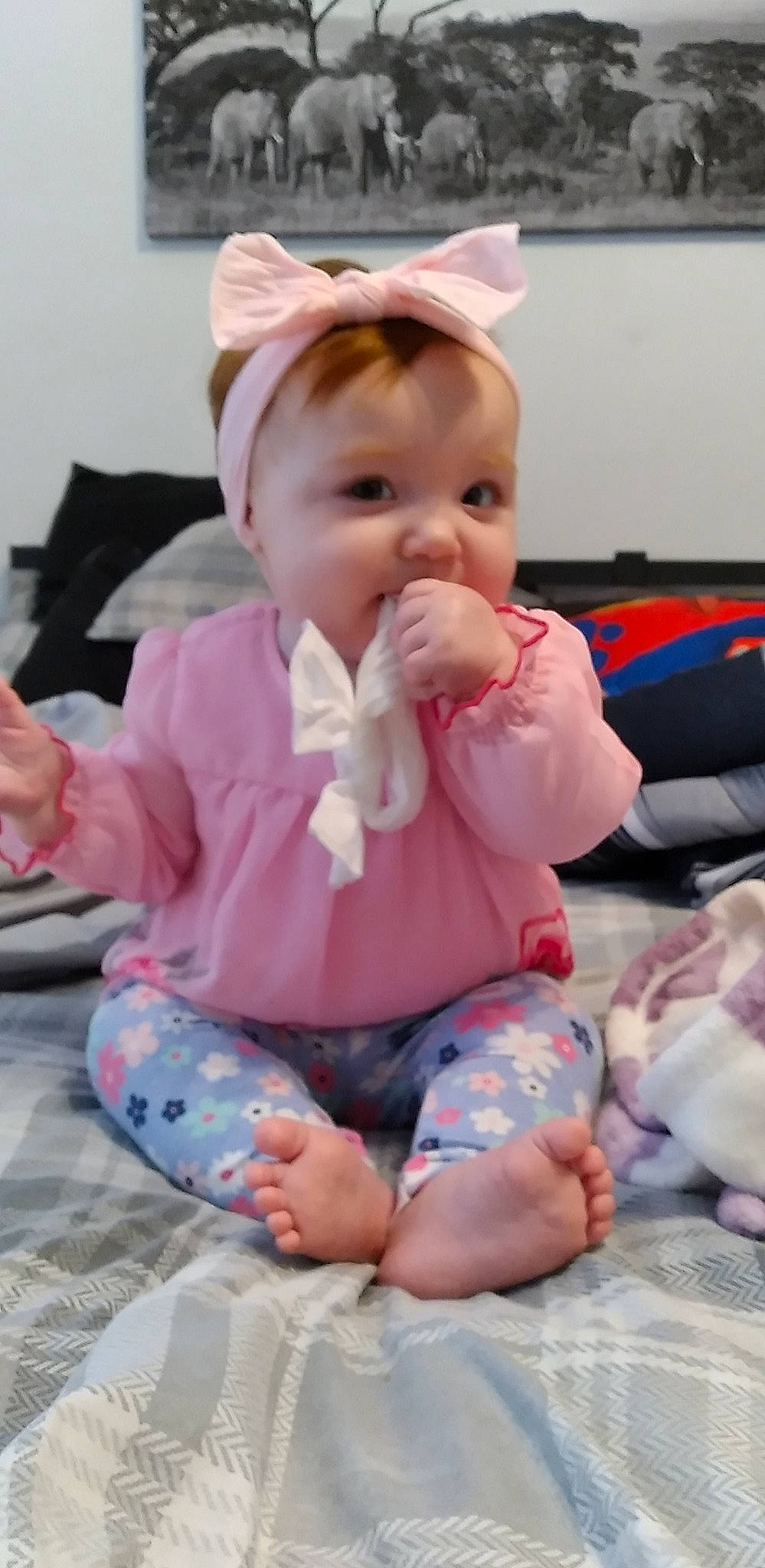 Rori is registered to the contest to win money with this photo: baby, baby_products, baby_toddler_clothing, barefoot, cheek, child, comfort, drinkware, eye, foot, fun, happy, human_body, lap, person, pink, room, sitting, skin, sleeve