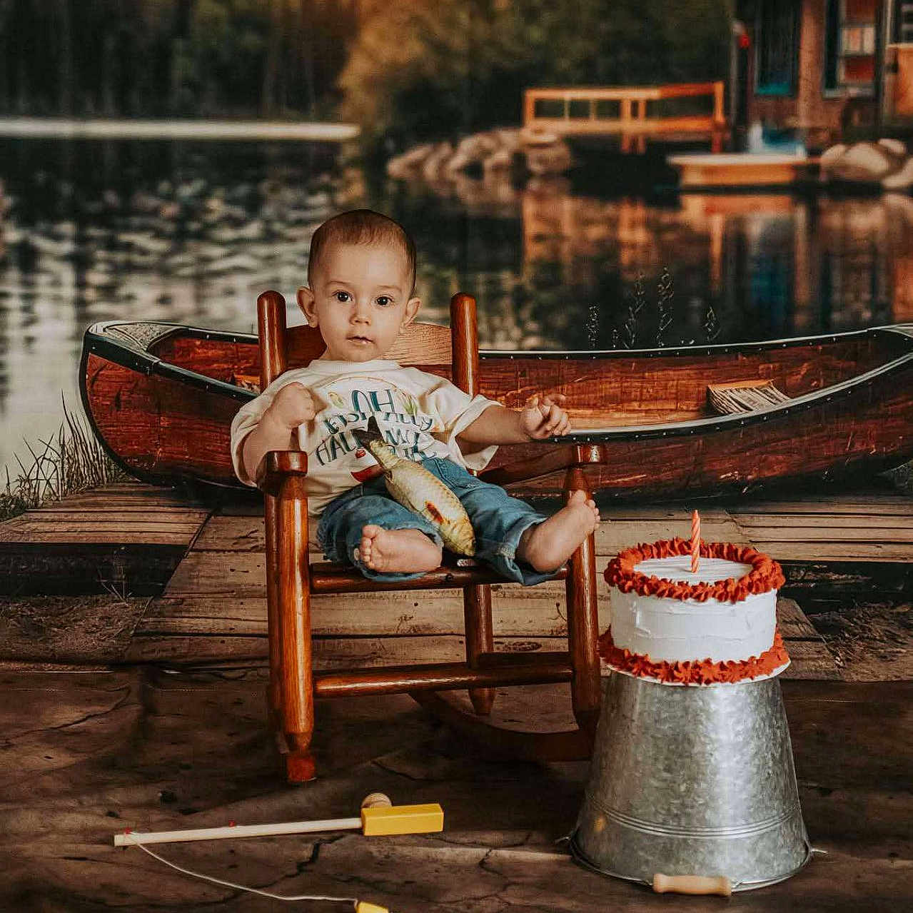 Creed joined the competition — help win amazing prizes! birthday_cake, cabin, candle, canoe, celebration, child, fishing_rod, lake, metal_bucket, nature, outdoor_scene, portrait, rocking_chair, rustic, smiling, toddler, toy_fish, water, wood, wooden_dock