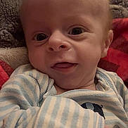 Cooper joined the competition — help win amazing prizes! baby, infant, newborn, child, face, eyes, smile, onesie, striped_clothing, blanket, bedding, cozy, hand, portrait, closeup, indoors, cute, adorable, skin, gaze