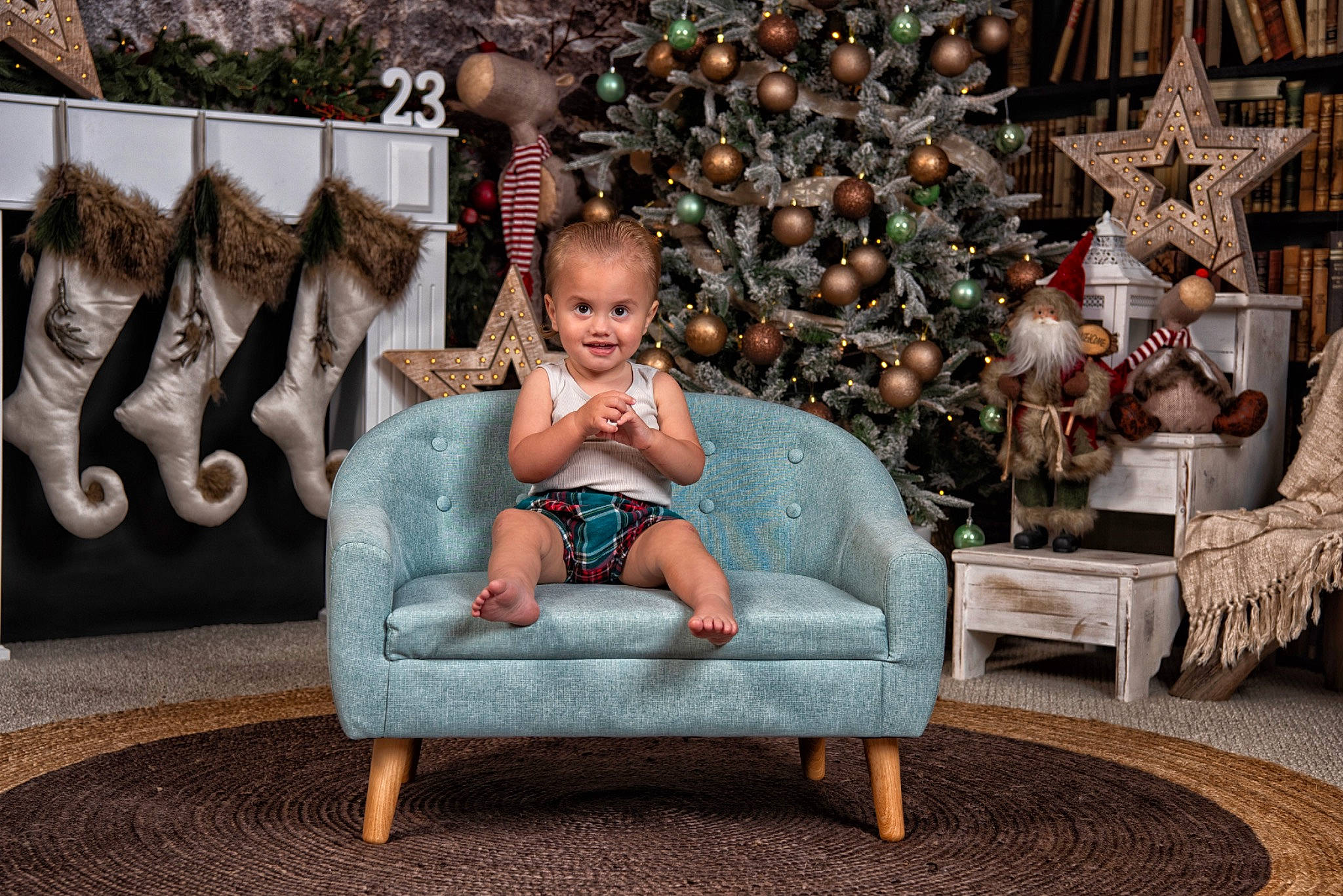 Zakai is registered to the contest to win money with this photo: christmas, christmas_decoration, christmas_ornament, christmas_tree, comfort, conifer, event, foot, fun, holiday, interior_design, jewellery, joy, lap, leisure, ornament, person, room, sitting, toddler