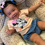 Christine joined the competition — help win amazing prizes! toddler, child, smiling, hair_bows, minnie_mouse, tshirt, denim_shorts, stuffed_animal, fluffy, cute, happy, indoors, playful, baby, person, portrait, sitting, clothing, joyful, relaxed