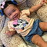 toddler, child, smiling, hair_bows, minnie_mouse, tshirt, denim_shorts, stuffed_animal, fluffy, cute, happy, indoors, playful, baby, person, portrait, sitting, clothing, joyful, relaxed
