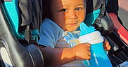 Kaizen joined the competition — help win amazing prizes! toddler, child, car_seat, sippy_cup, curly_hair, sunlight, shadow, baby_clothes, car_interior, seat_belt, infant, cute, young_child, person, portrait, sitting, holding, daylight, car_door, window